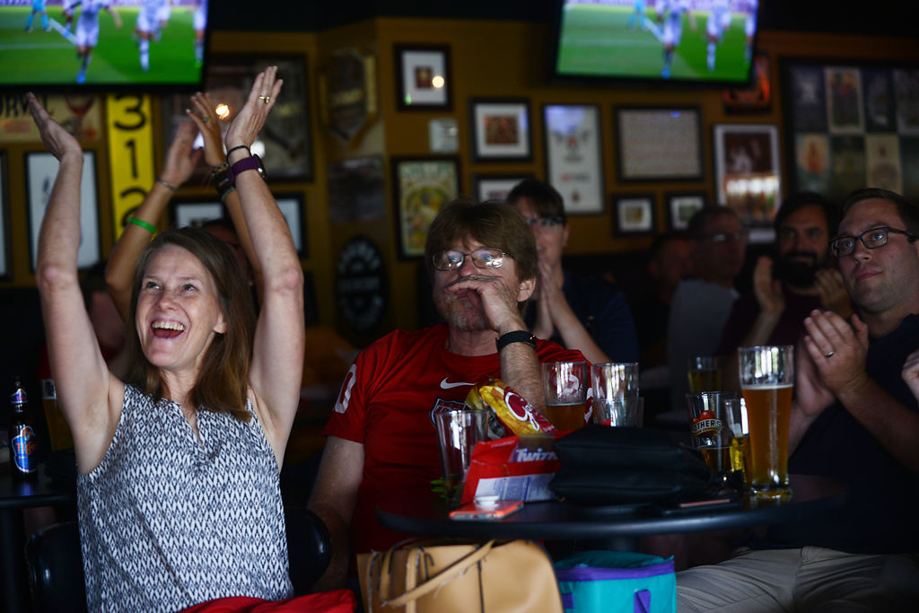 Katie and Larry Doescher, left and center, celebrate as midfielder Megan Rapinoe scored the first goal